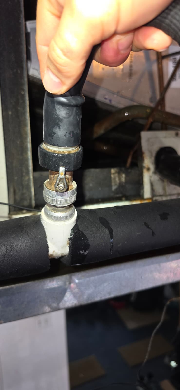 Technician adjusting pipe connection in Tampa, FL 33624.