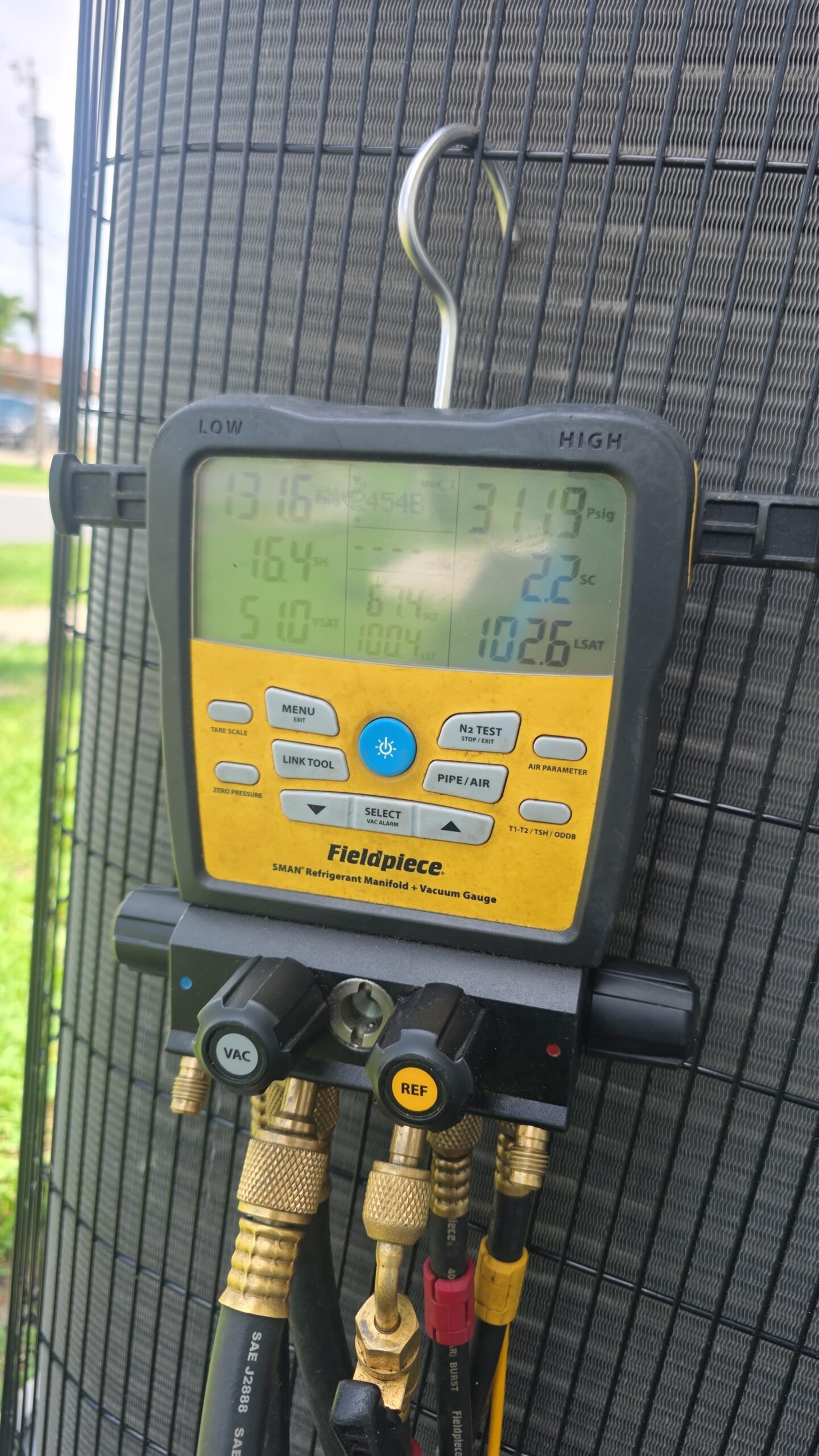 Fieldpiece manifold gauge set showing pressure readings in Largo, FL 33771.