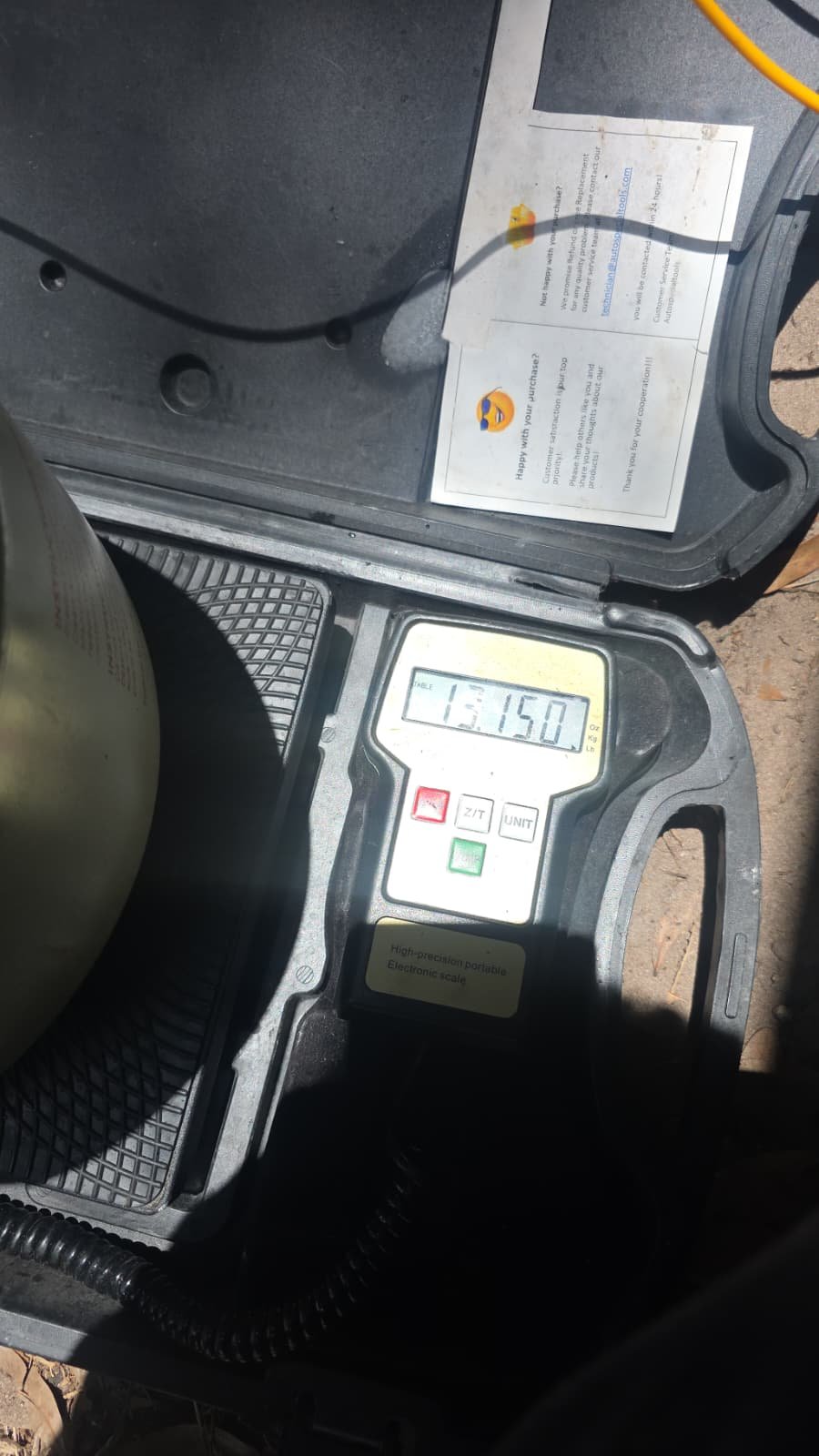 Digital scale displaying weight for refrigerant measurement in Riverview, FL 33579. In-progress AC service.