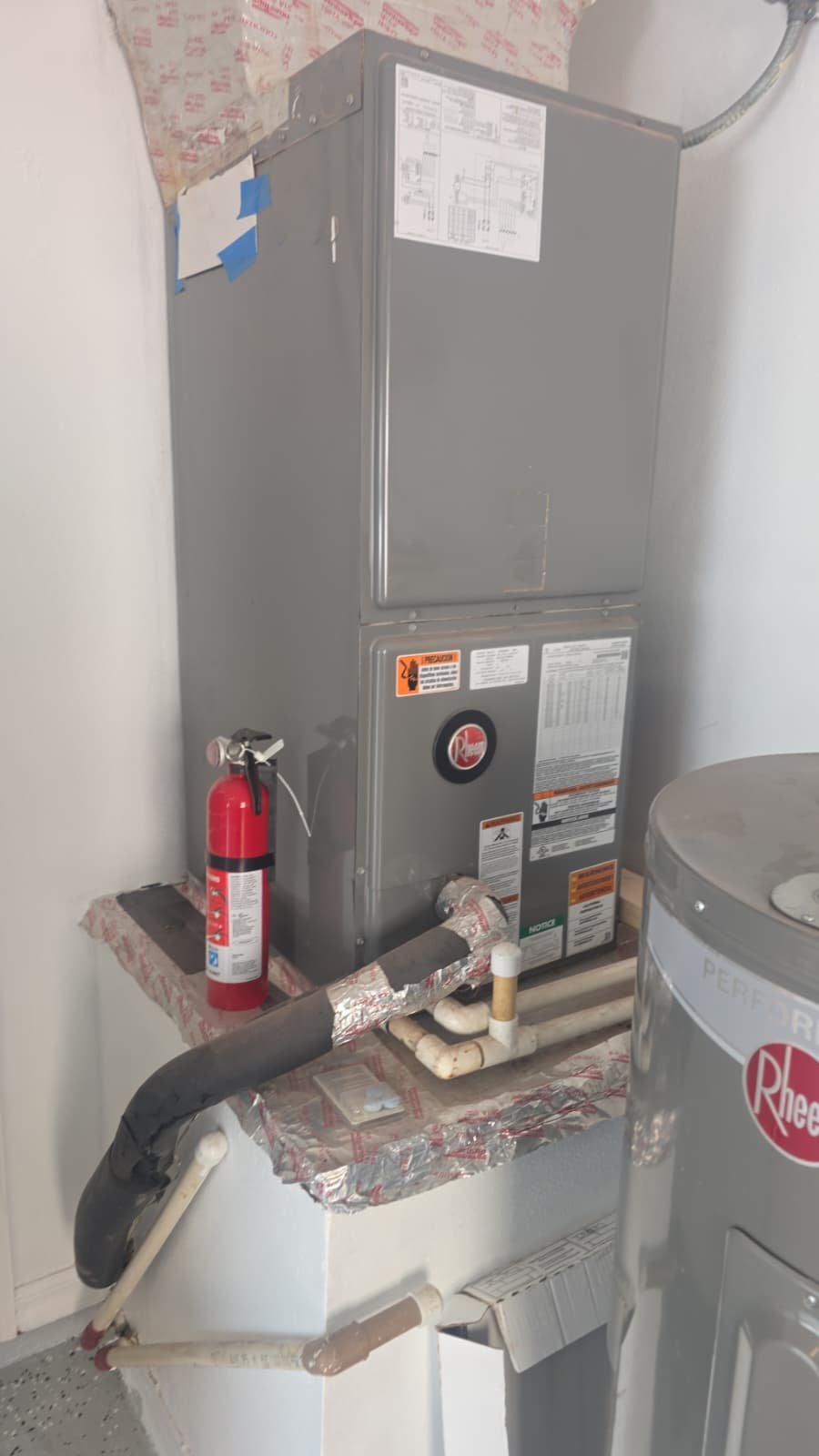Rheem HVAC Unit Installation - Tampa, FL 33607 Rheem HVAC unit installed indoors with extinguisher in Tampa, FL 33607.