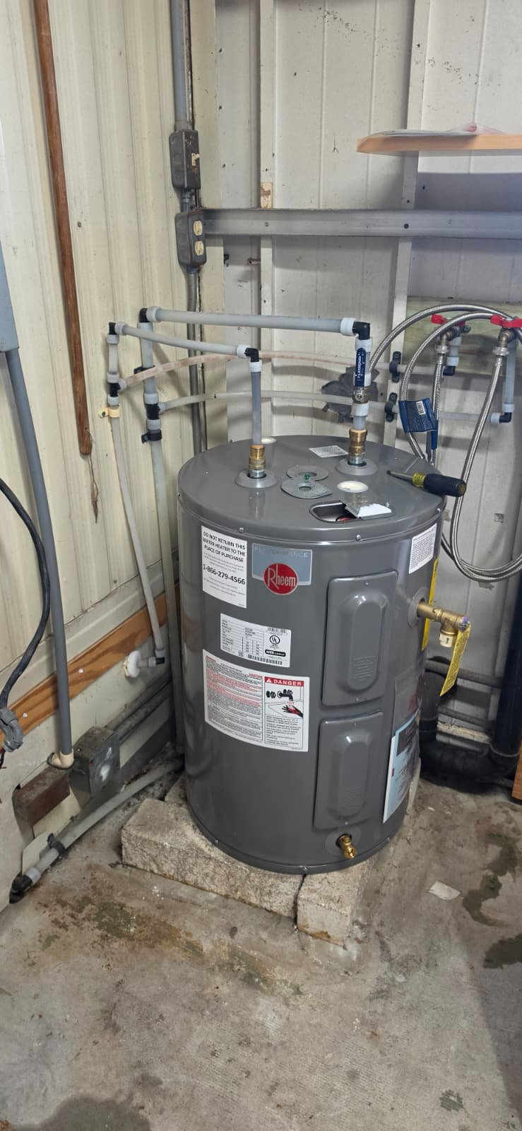 New Rheem water heater with updated plumbing in Port Richey, FL 34668. Quality installation.