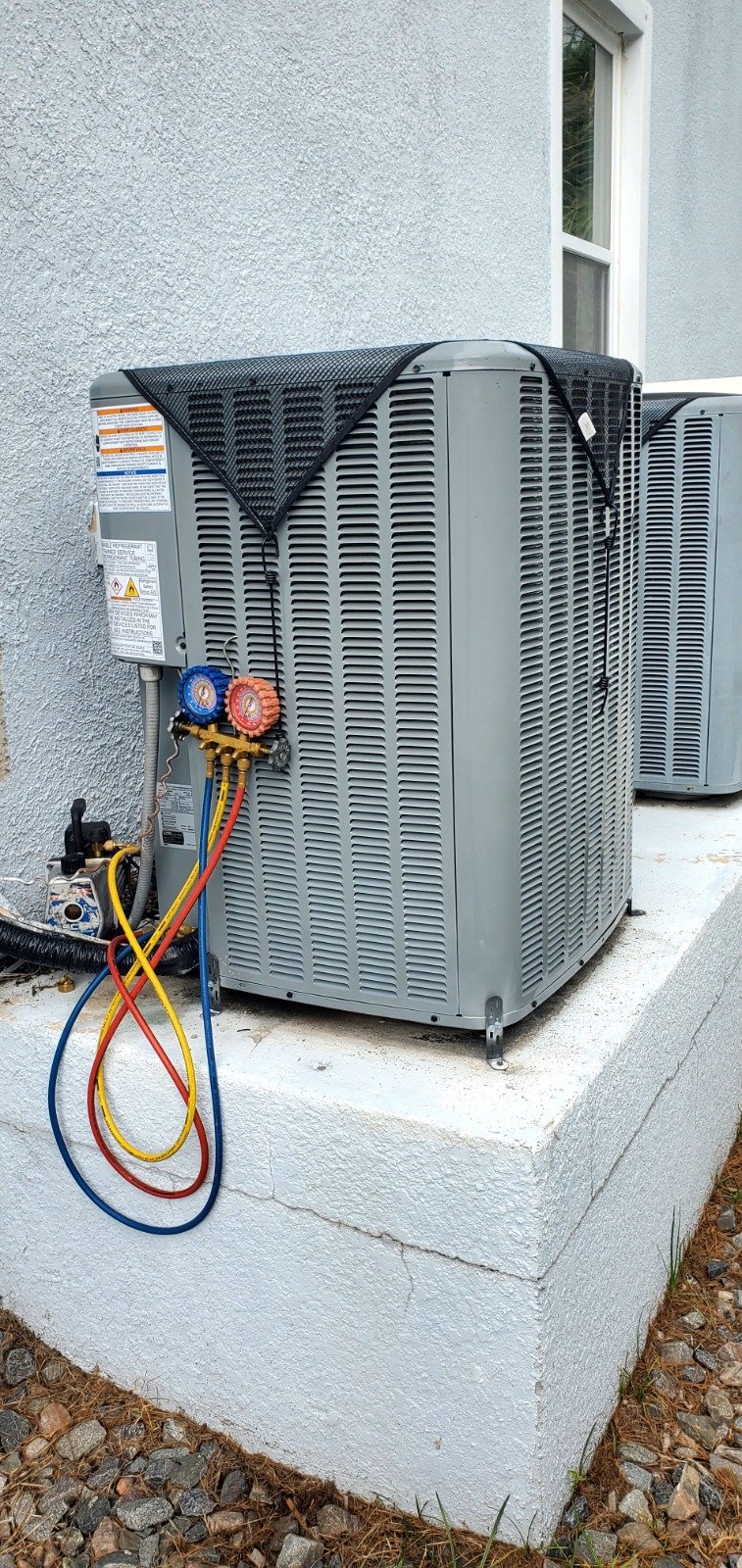 Side view of HVAC unit on concrete pad in Tampa, FL 33616.