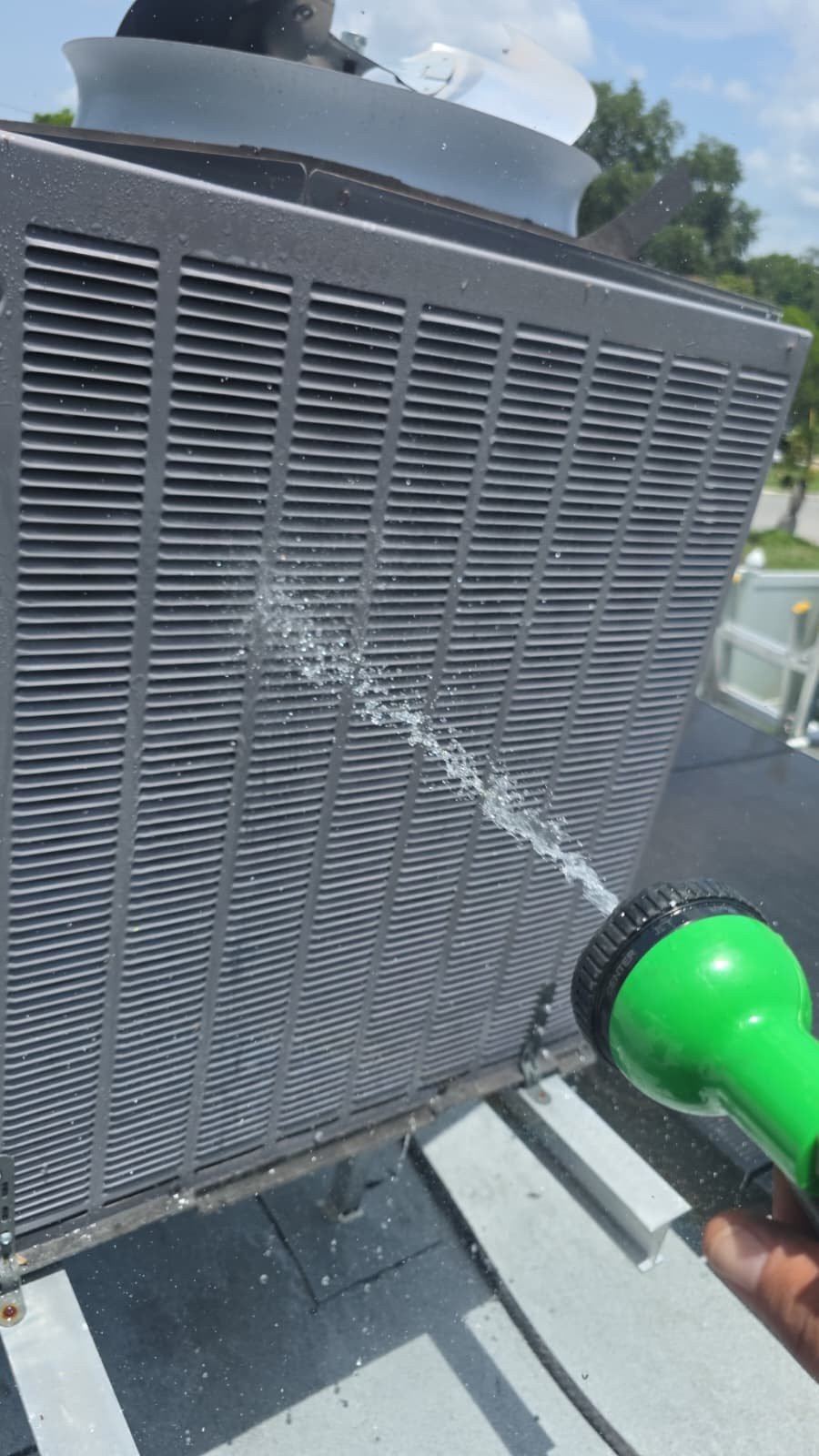 Spraying HVAC Unit for Cleaning - Largo, FL 33773 Spraying water on HVAC unit for cleaning in Largo, FL 33773.
