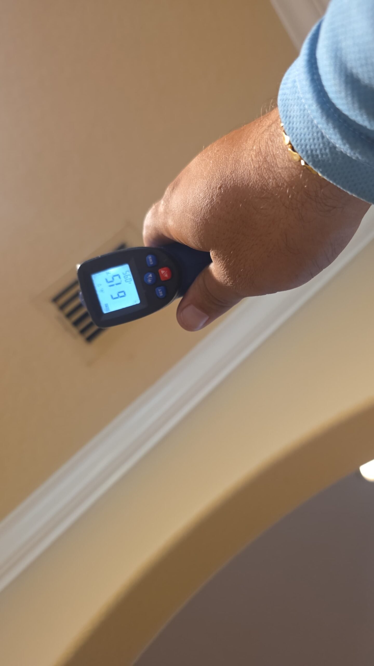 Temperature gun at ceiling vent during Elite Therapy Visit #7, Bradenton, FL 34202.