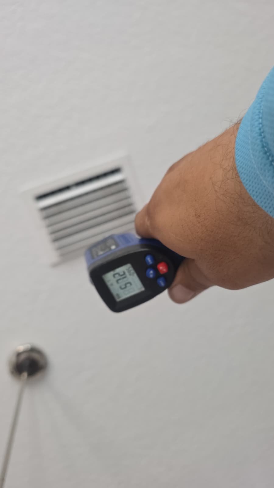 Temperature Check - Tampa, FL 33611 Temperature gun aimed at wall vent during HVAC service, Tampa, FL 33611.