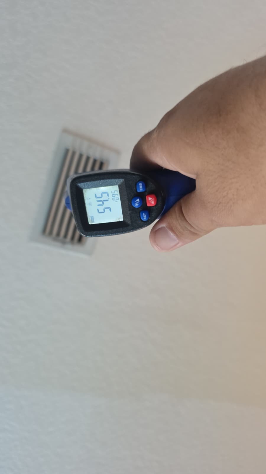 Temperature reading from ceiling vent using digital thermometer during Premium Therapy Plan in Tarpon Springs, FL 34689.