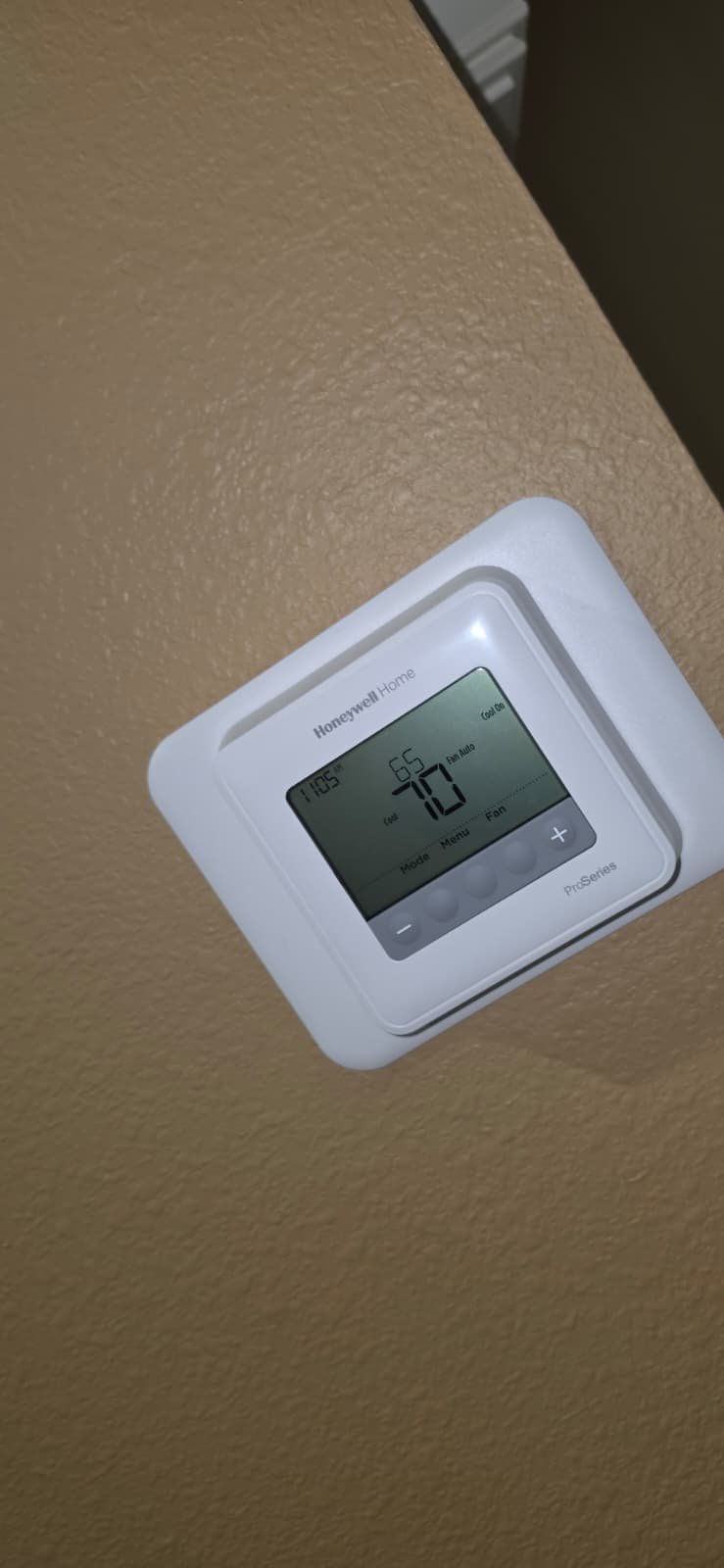 Close-up of Honeywell Home thermostat displaying temperature in Lutz, FL 33559.