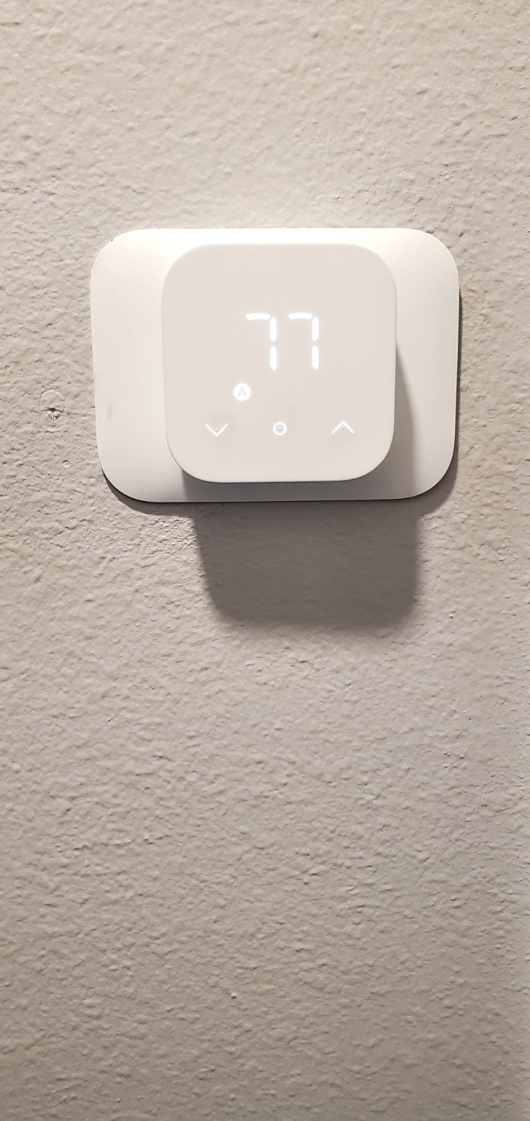 Wall-mounted thermostat displaying temperature in Tampa, FL 33616.
