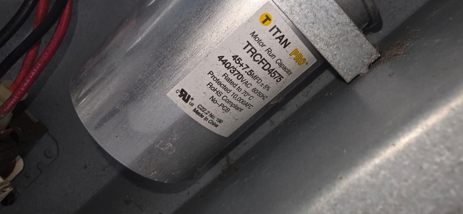 Titan Capacitor in HVAC Unit - Tampa, FL 33612 Close-up of Titan capacitor inside HVAC unit for repair in Tampa, FL 33612.
