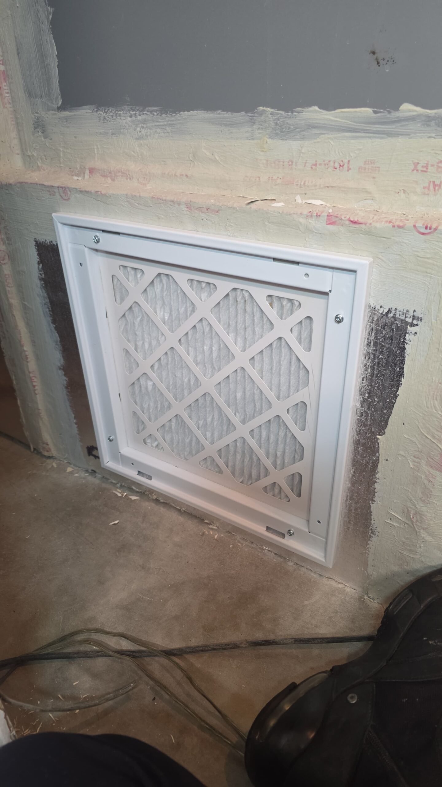 Installed vent cover with filter on a wall, Tampa, FL 33606.