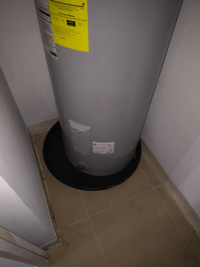 A water heater sitting in its drain pan in Tampa, FL 33647.
