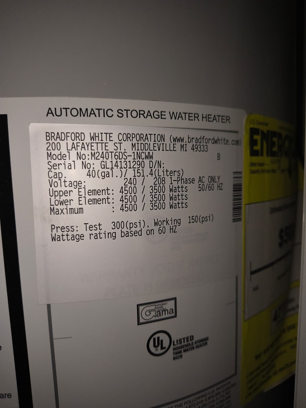 Close-up of water heater label with specs, Tampa, FL 33647. Energy-efficient details.