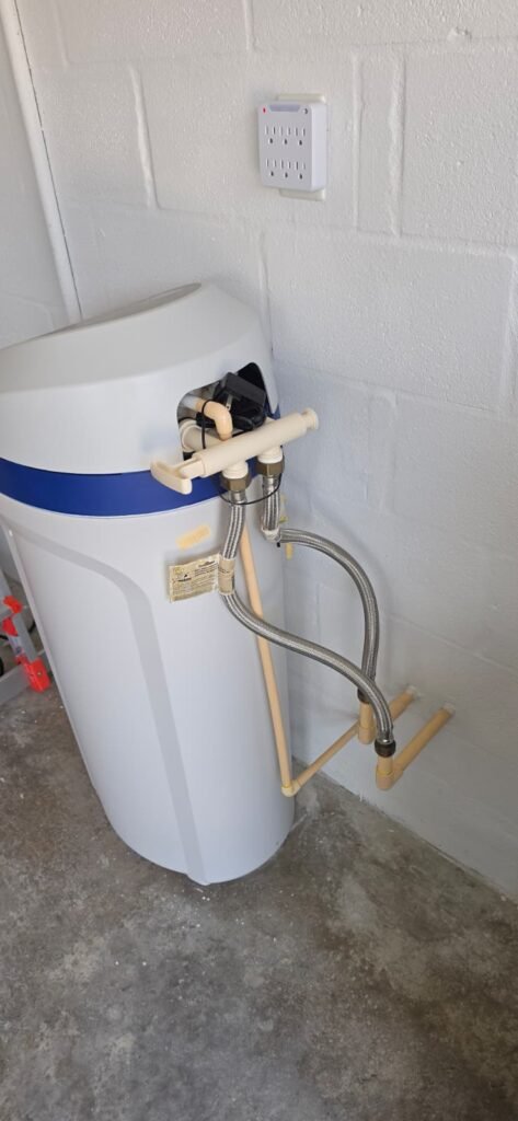 A cabinet-style water softener in a garage in Riverview, FL 33578.
