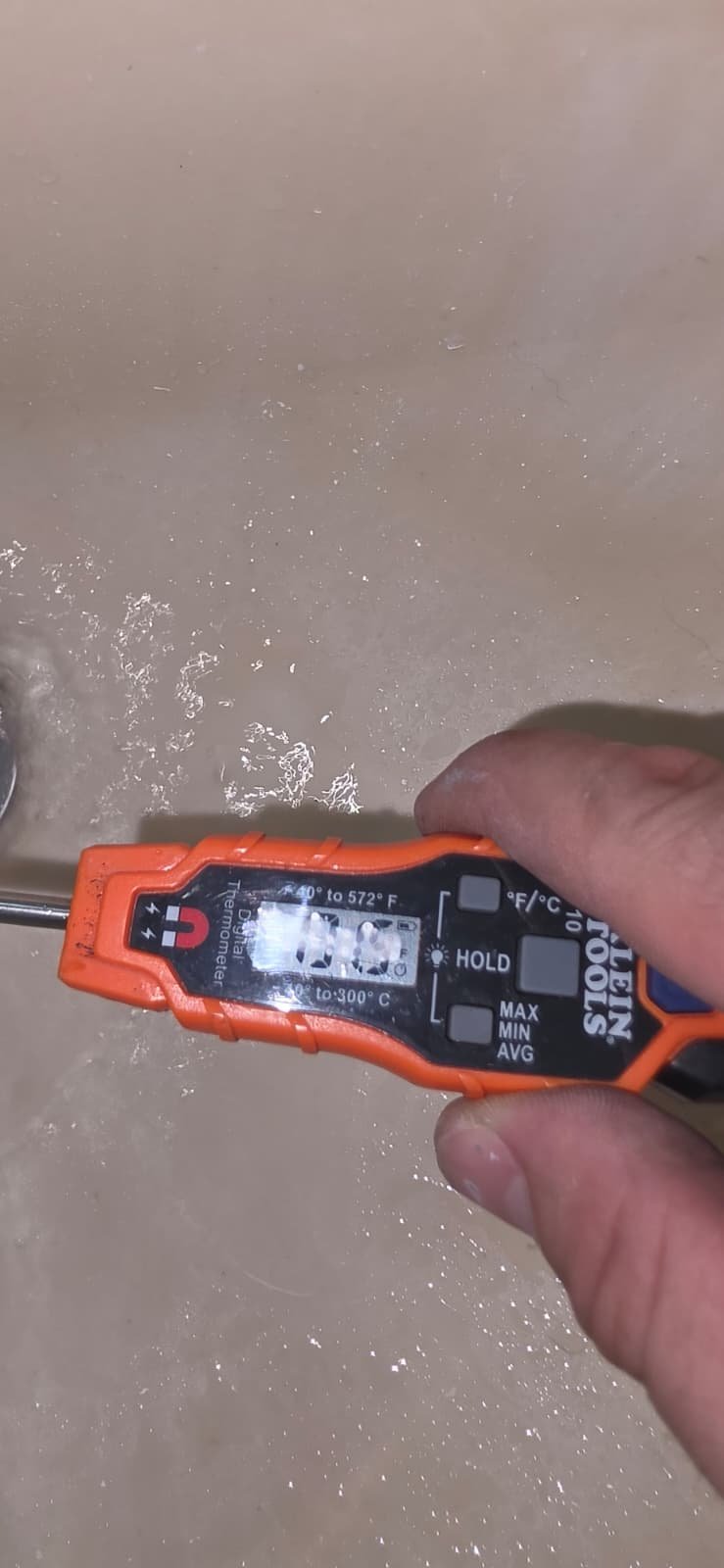 Thermometer measuring water temperature in tub, Port Richey, FL 34668. Ensuring comfort.