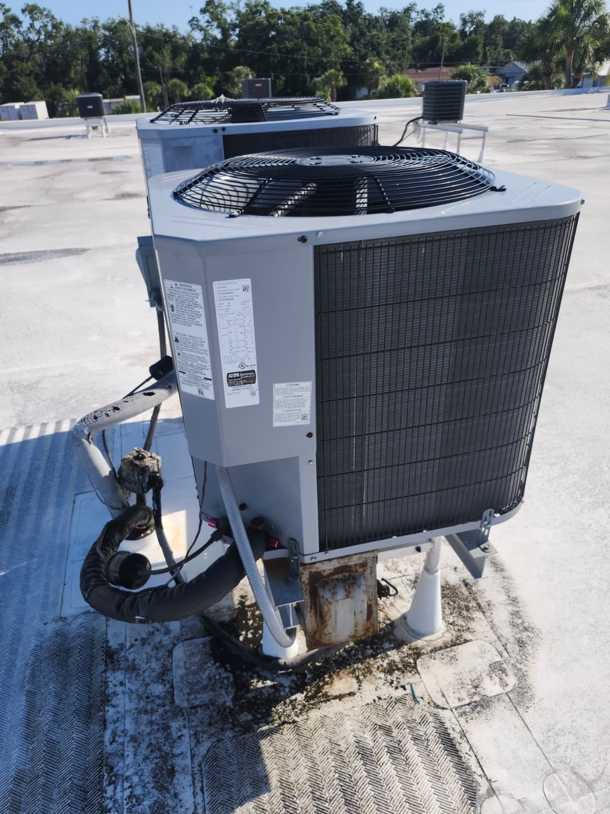 HVAC unit with wear and tear on rooftop in Tampa, FL 33634.