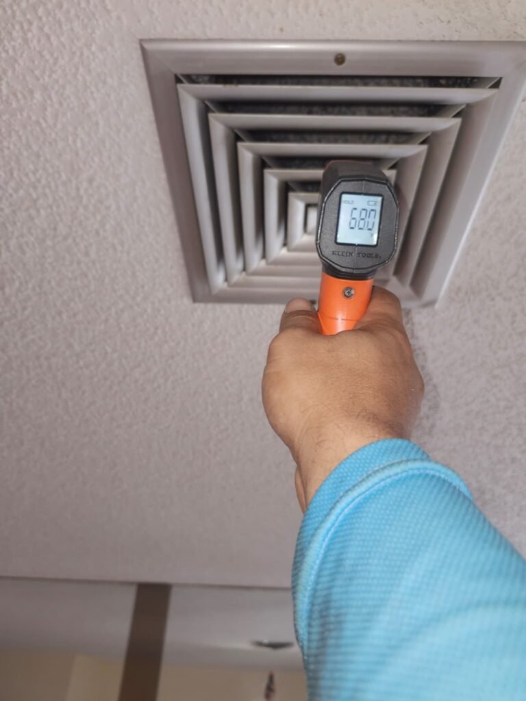 Technician measuring air temperature at vent, New Port Richey, FL 34653
