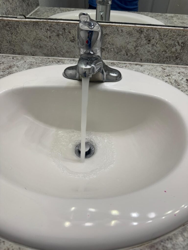 Bathroom sink with water flowing in Wesley Chapel, FL 33545