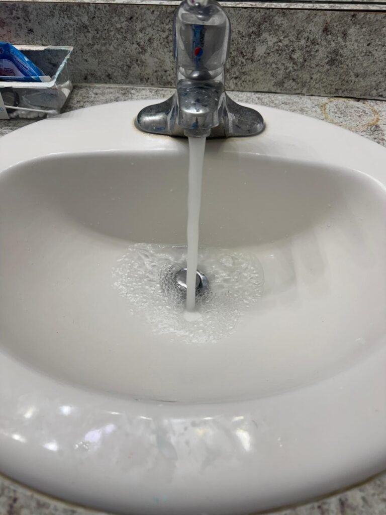 Bathroom sink with running water in Wesley Chapel, FL 33545