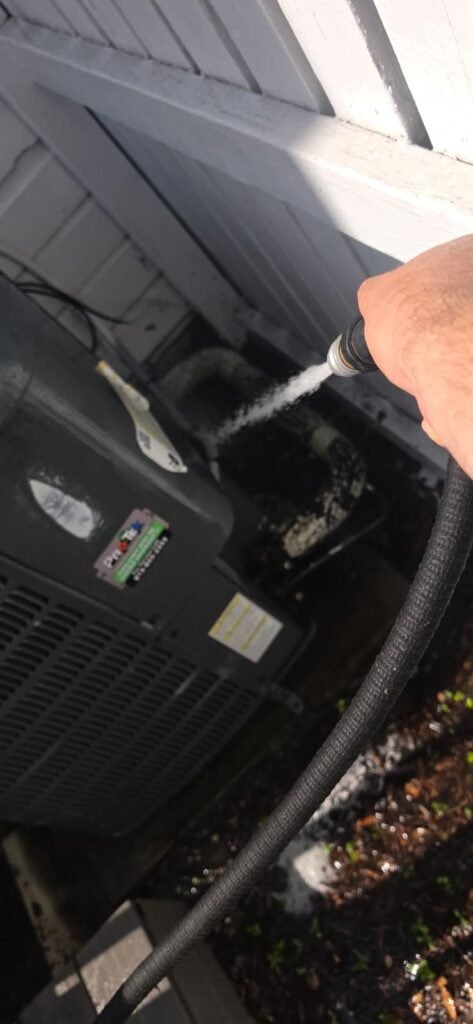 AC Unit Cleaning in Progress, Tampa, FL 33605 Technician cleaning AC unit during service, Tampa, FL 33605