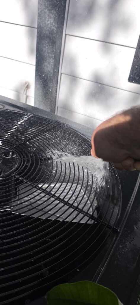Cleaning HVAC unit fan during service in Tampa, FL 33603