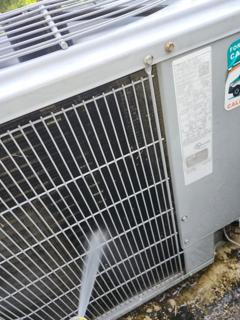 Cleaning Outdoor HVAC Unit in Tampa, FL 33647 Water spraying on HVAC unit for cleaning, Tampa, FL 33647