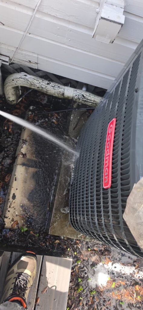 Hose Cleaning AC Unit in Tampa, FL 33605 Hose spraying water on AC unit during cleaning, Tampa, FL 33605