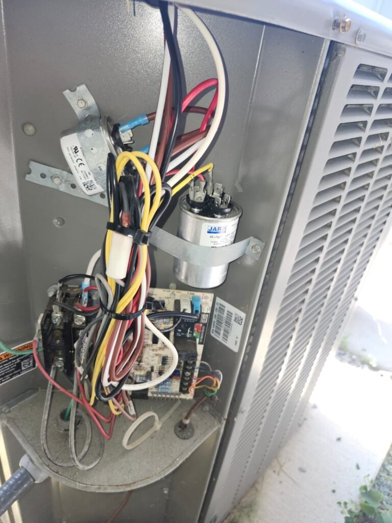 Inside view of HVAC unit with wiring and capacitor in Riverview, FL 33578