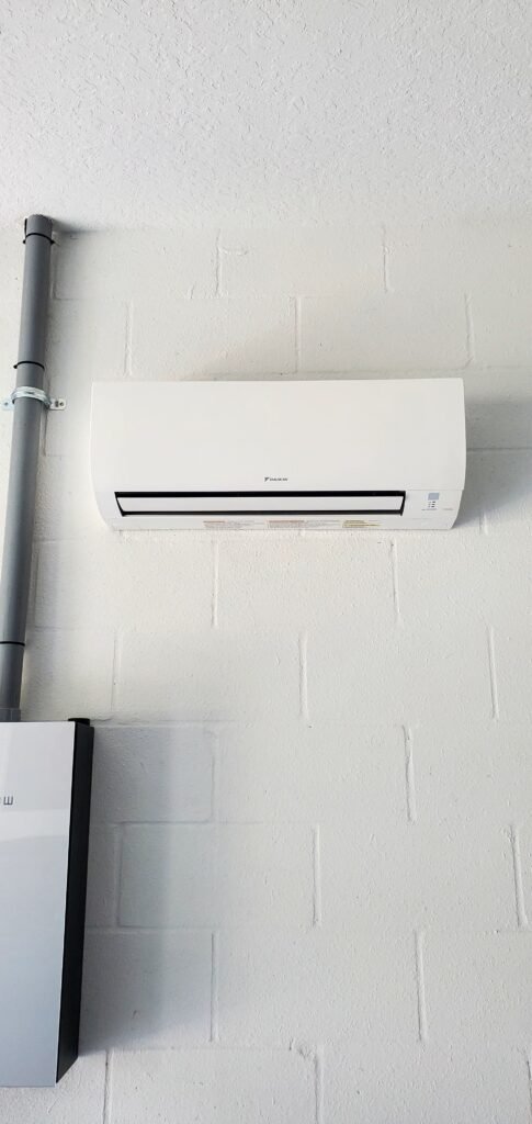 A Daikin ductless mini split head on a block wall in Land O’ Lakes, FL 34638.