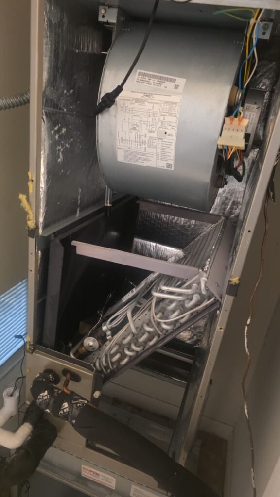An open air handler showing the blower and coil in Tampa, FL 33618.