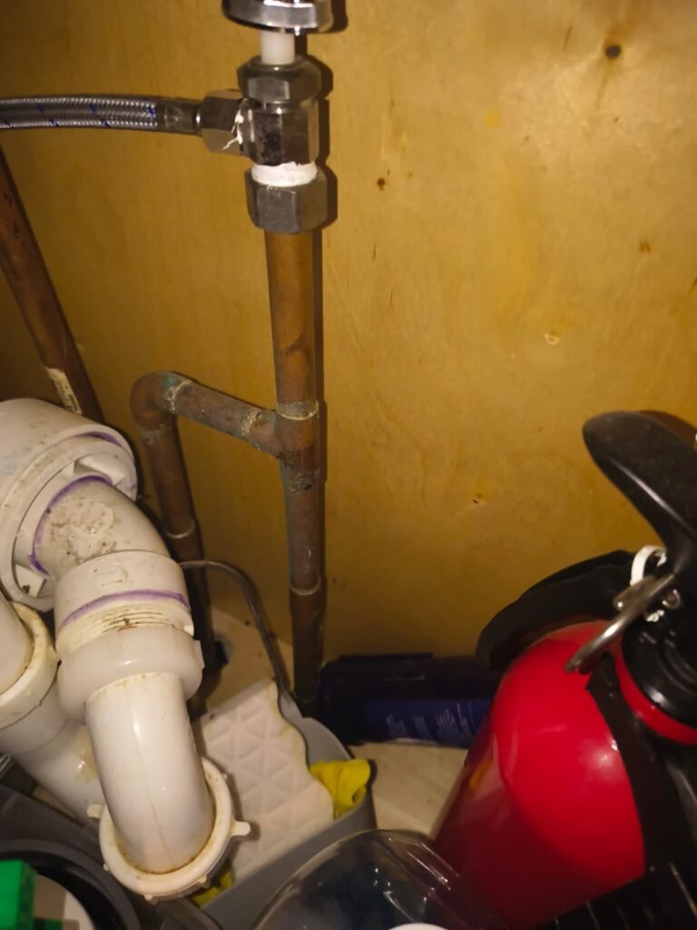 Close-up of plumbing pipes under sink, Tampa, FL 33635