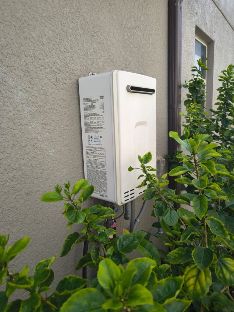 A tankless water heater mounted on an outside wall in New Port Richey, FL 34655.