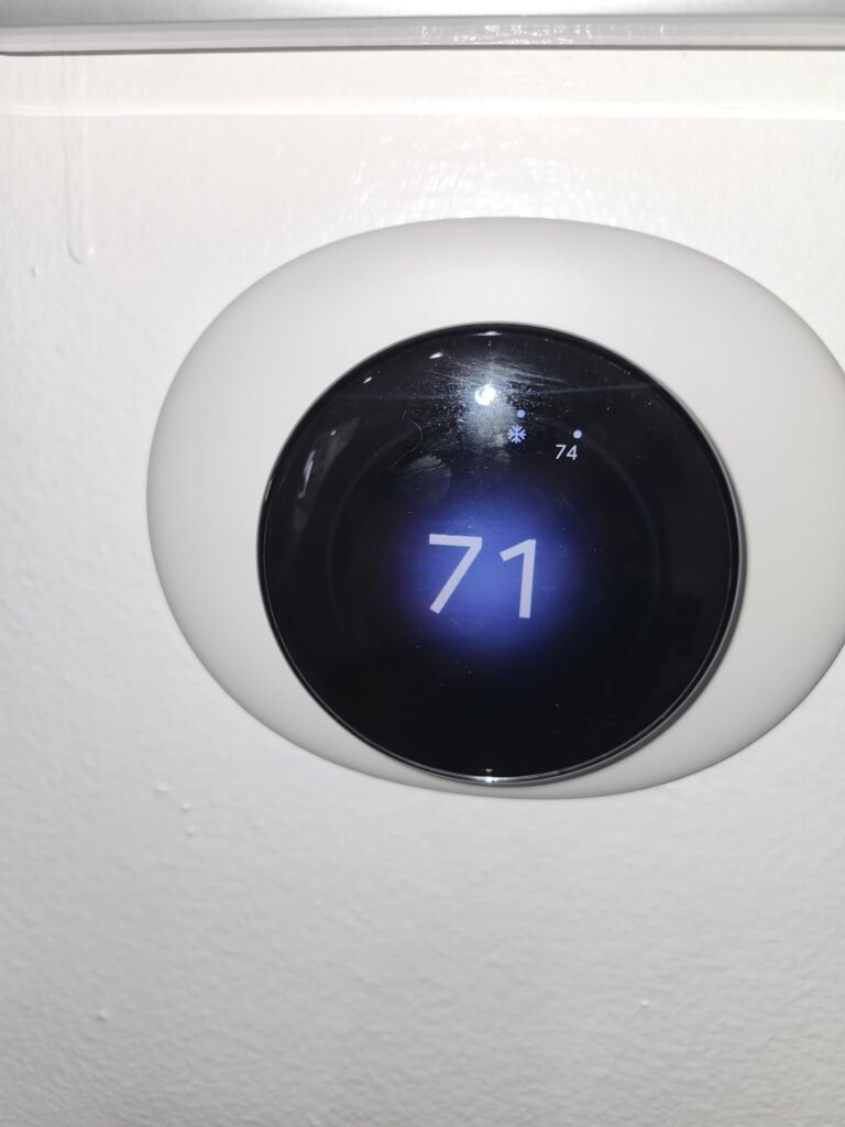 Digital thermostat showing 71 degrees in Tampa, FL 33624
