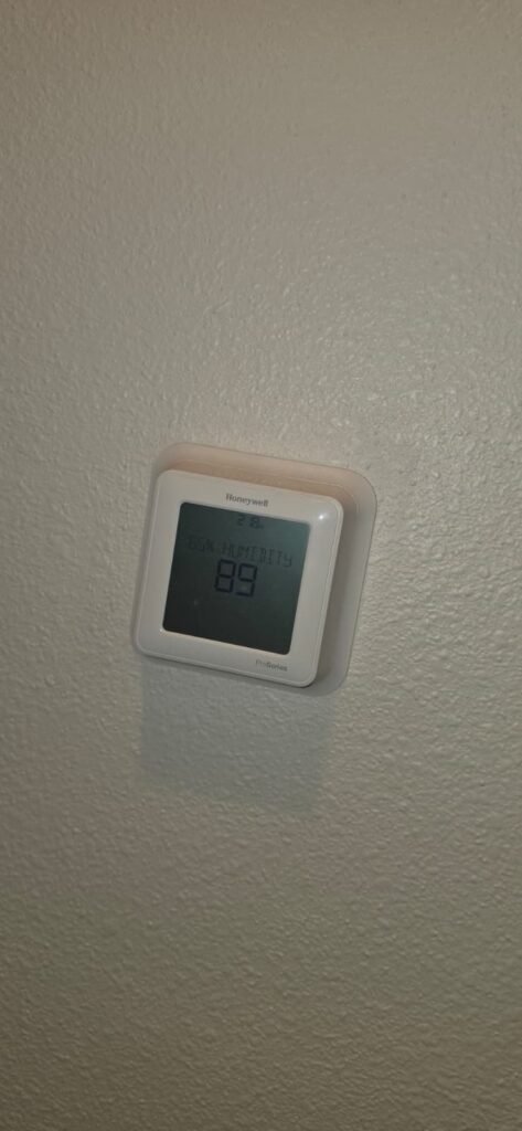 A Honeywell thermostat showing the indoor humidity reading in Wesley Chapel, FL 33545.