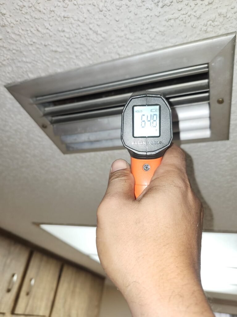 Checking air temperature at vent with thermometer, New Port Richey, FL 34653