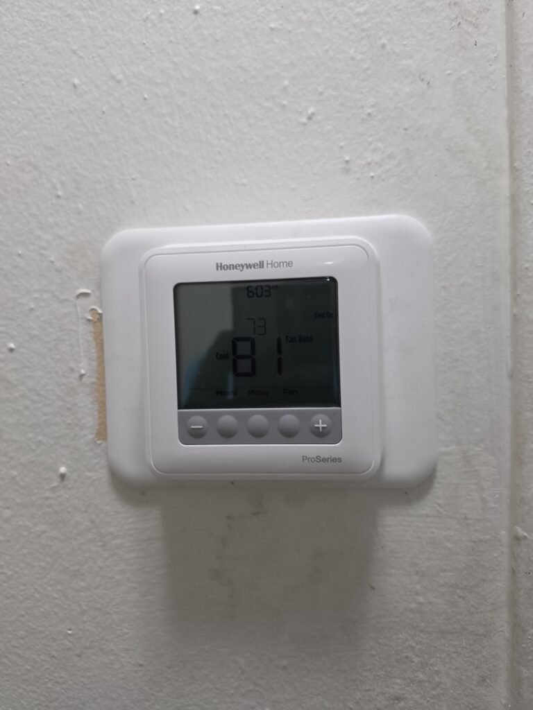 Wall Thermostat in Tampa, FL 33611 Thermostat on wall showing 81 degrees in Tampa, FL 33611 HVAC service.