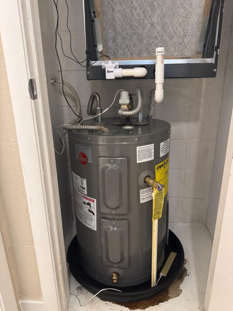 A new Rheem tank set in a drain pan inside a closet in Tampa, FL 33611.