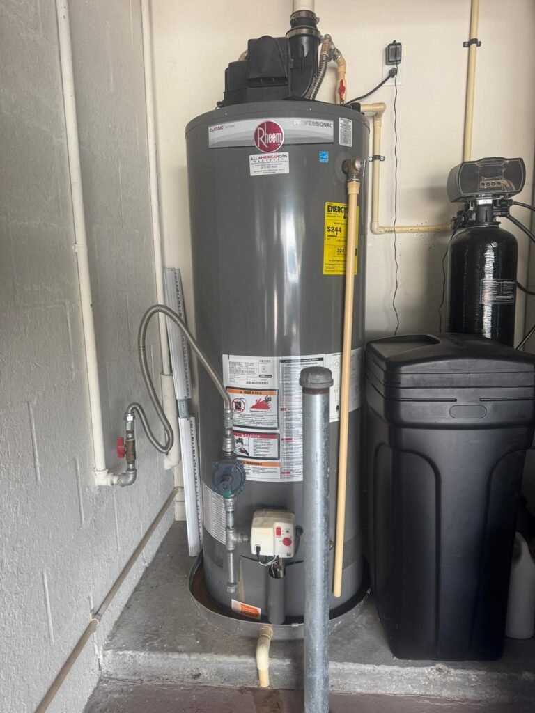 A Rheem gas water heater next to a water softener in Tampa, FL 33626.
