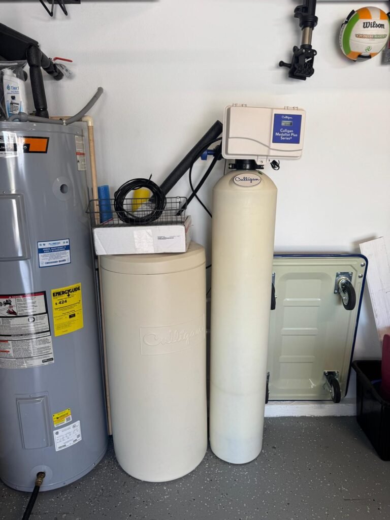 A salt-based softener and brine tank next to the water heater in Lutz, FL 33558.
