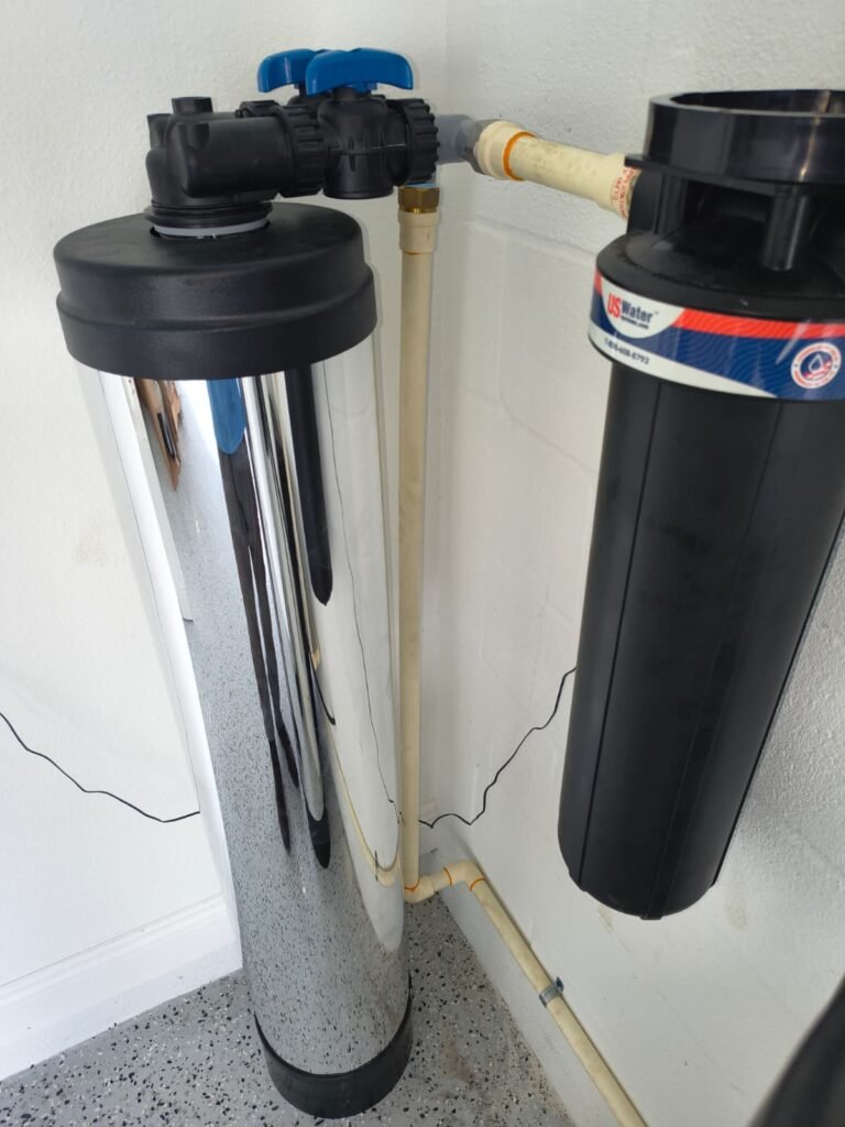 A large cartridge filter housing next to a softener tank in San Antonio, FL 33576.