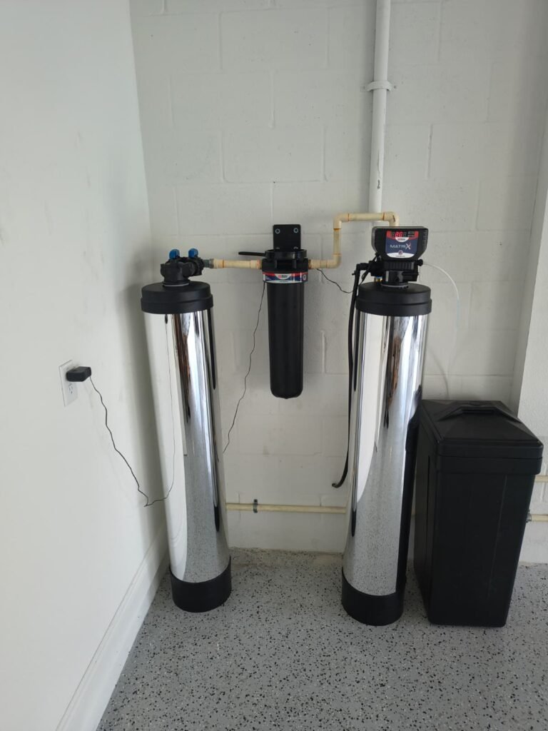Two treatment tanks, a cartridge pre-filter and a brine tank we installed in a garage in San Antonio, FL 33576.