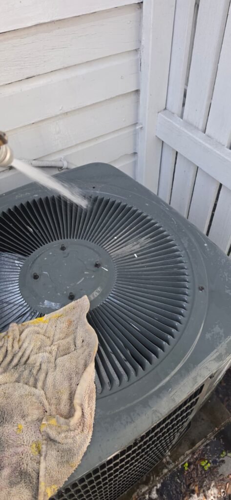 Water Spray Cleaning AC Unit, Tampa, FL 33605 Spraying water on AC unit for cleaning, Tampa, FL 33605