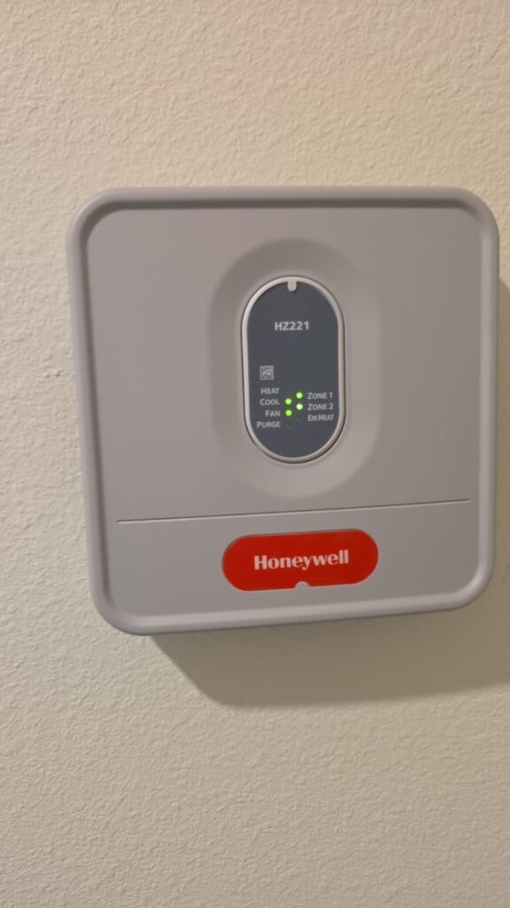A Honeywell zone control panel mounted on a wall in Tampa, FL 33618.