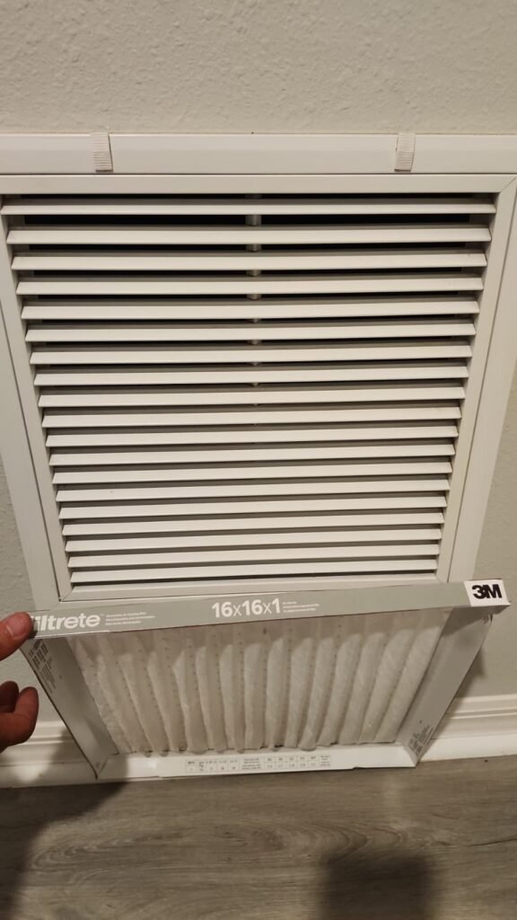 A clean filter going into a wall return grille in Tampa, FL 33610.