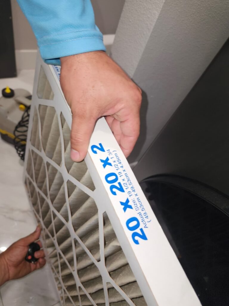 Swapping in a new air filter during AC maintenance in St. Petersburg, FL 33703.