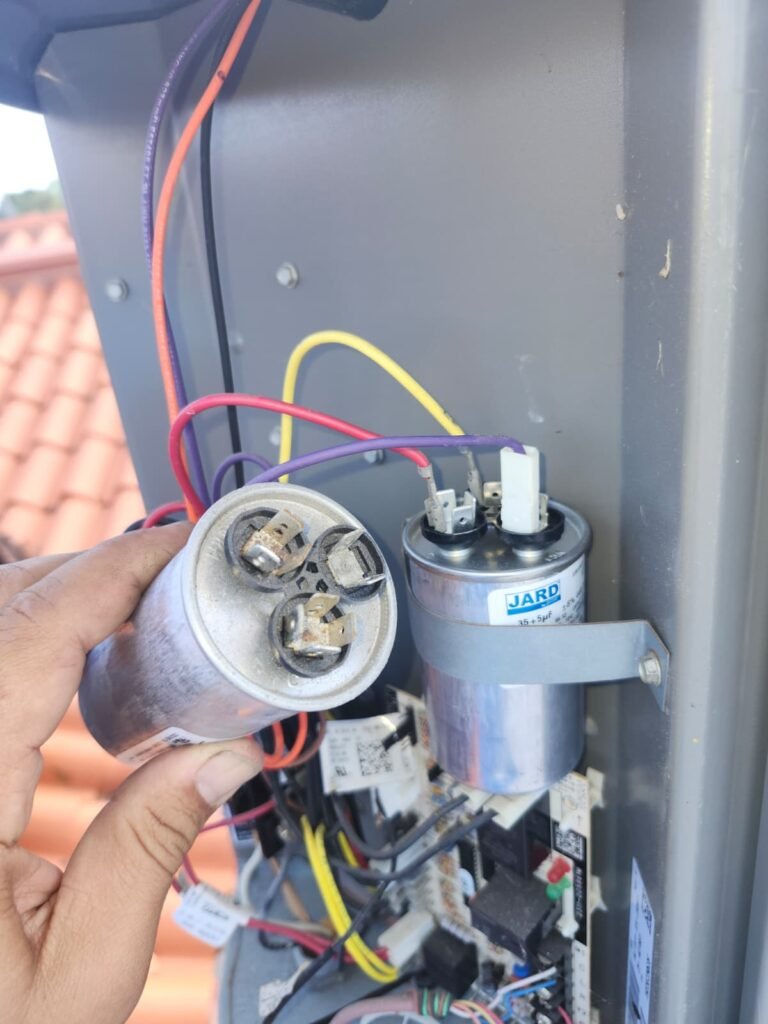 An old capacitor next to its new replacement during a repair in St. Petersburg, FL 33703.