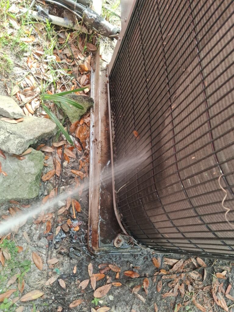 Cleaning AC unit with water spray in Tampa, FL 33605