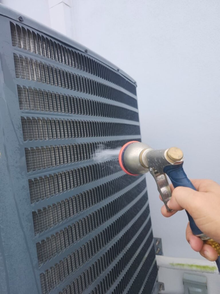 Cleaning Condenser Unit in Saint Petersburg, FL 33703 Cleaning condenser unit with hose, Saint Petersburg, FL 33703