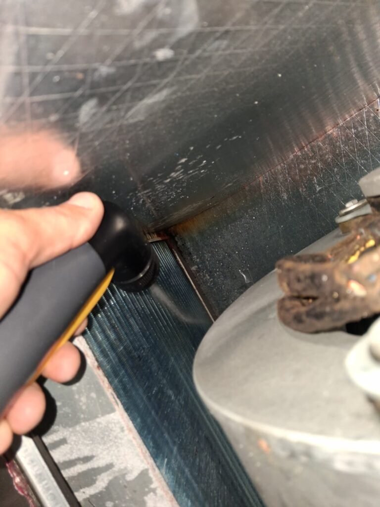 Technician cleaning inside HVAC component in Tampa, FL 33605