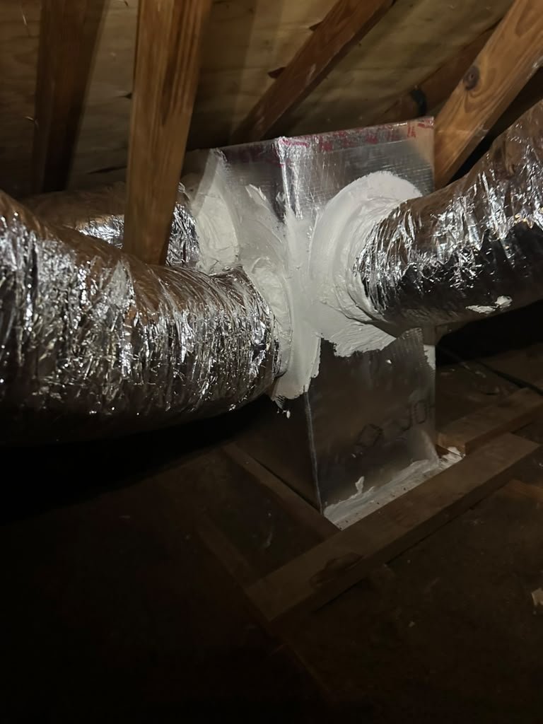 New R-6 flex duct runs joined at a sealed junction box in an attic in Tampa, FL 33625.