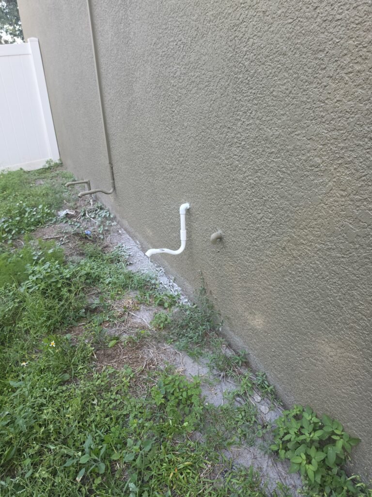 Exterior PVC drain line installation in Ruskin, FL 33570.